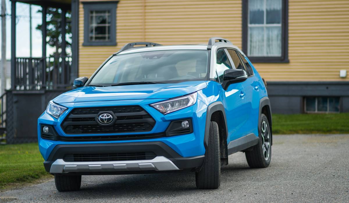 Blue 2020 Toyota RAV4 Adventure with a white roof, parked on a gravel driveway